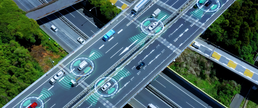 Aerial view of a smart highway with connected vehicles displaying digital safety zones, representing verification and validation services.