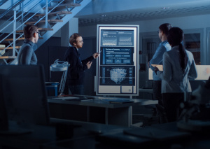 Leaders in Digital Engineering showcasing a group of professionals discussing data on large digital screens.