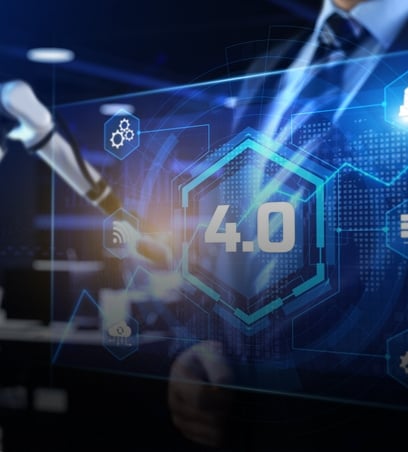Robotic arm working on a digital screen filled with glowing blue graphics, symbolizing advanced manufacturing operations