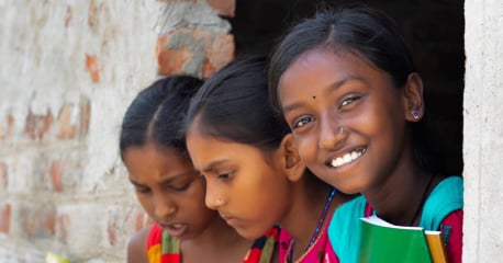 Young girls smiling while studying