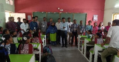 Employees teaching school children