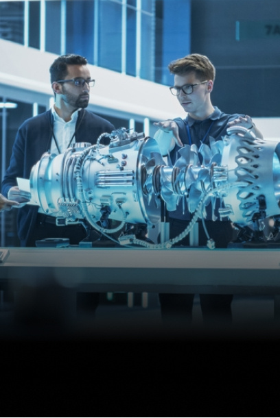 Workers collaborating across design, manufacturing and aftermarket.