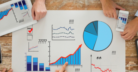 Professionals analyzing data visualizations and graphs, representing predictive analytics in mining.