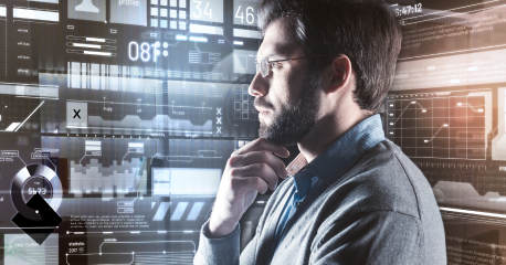 A professional analyzing digital interfaces and data streams, emphasizing the importance of smart, connected equipment for business advantage.